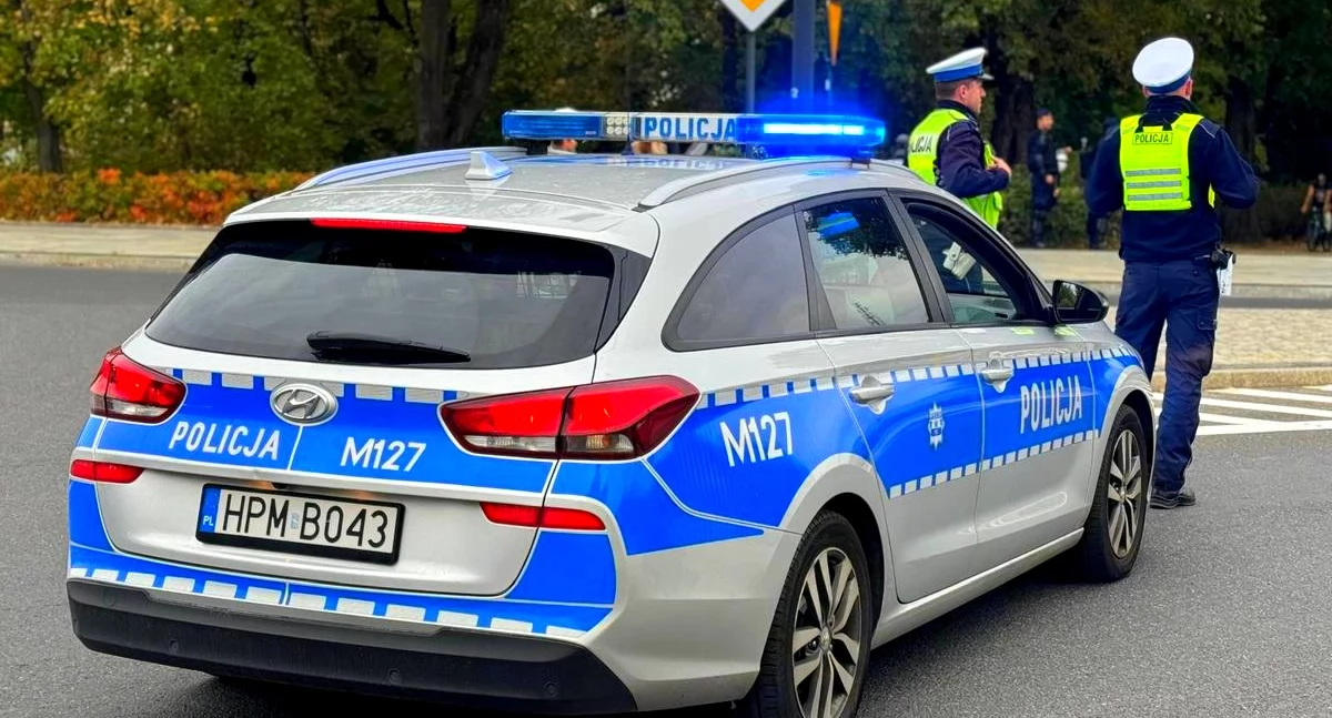Zdjęcie policjantów drogówki przy radiowozie/ podlaska.policja.gov.pl