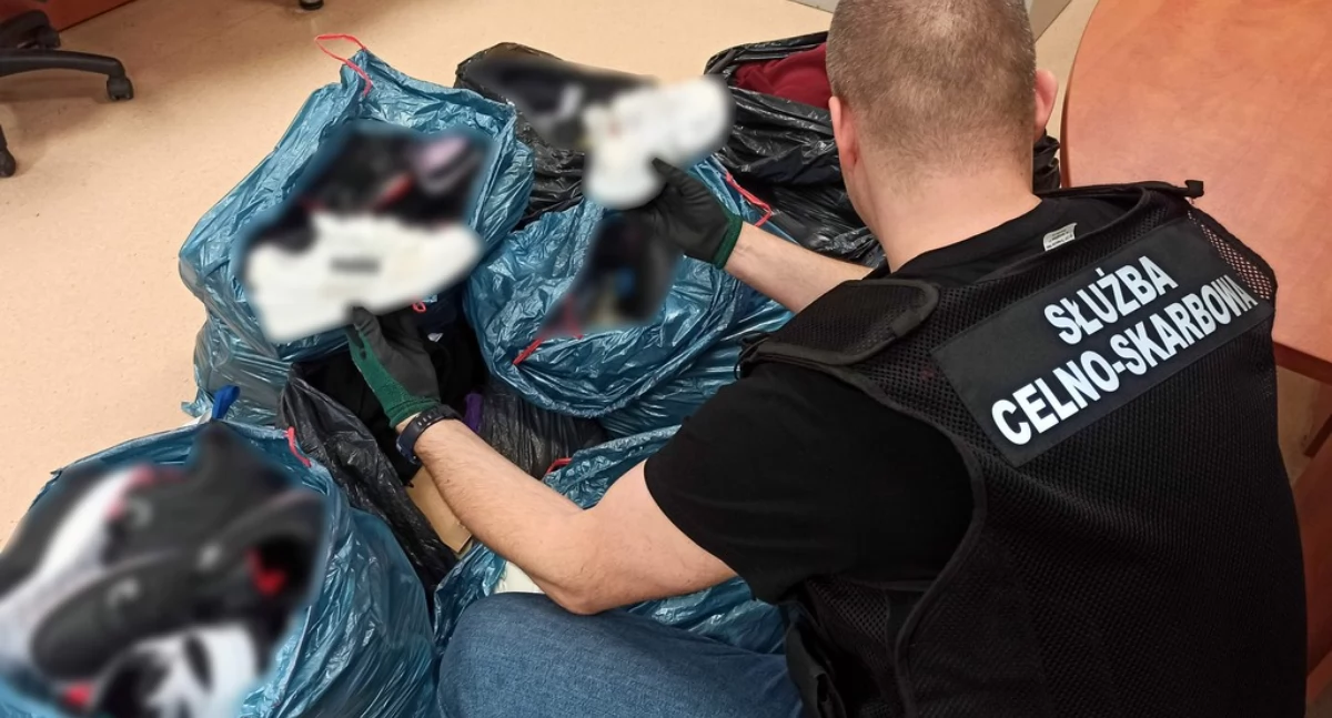Zdjęcie funkcjonariusza KAS przy zarekwirowanym towarze/ KAS